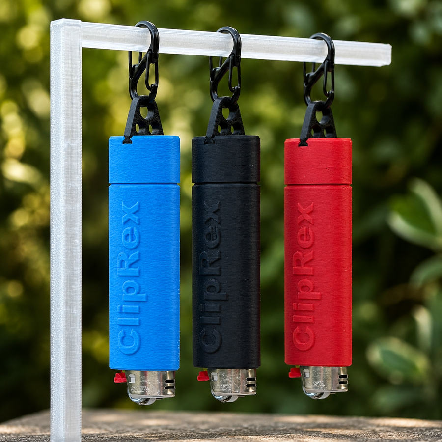 ClipRex lighter holders in blue, black and red, each clipped to a rail with a black carabiner and holding a full-size lighter