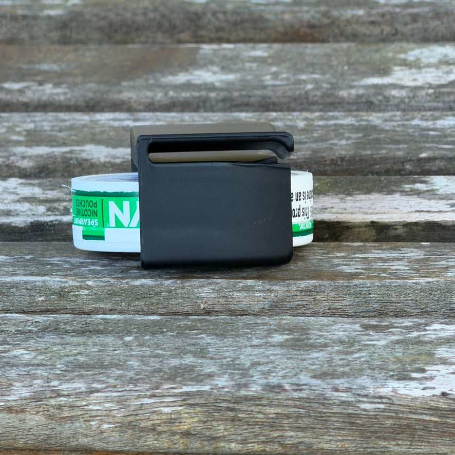 Rear view of the black Pouch Holster showing the flat slide-on clip tab, with the pouch can visible behind it